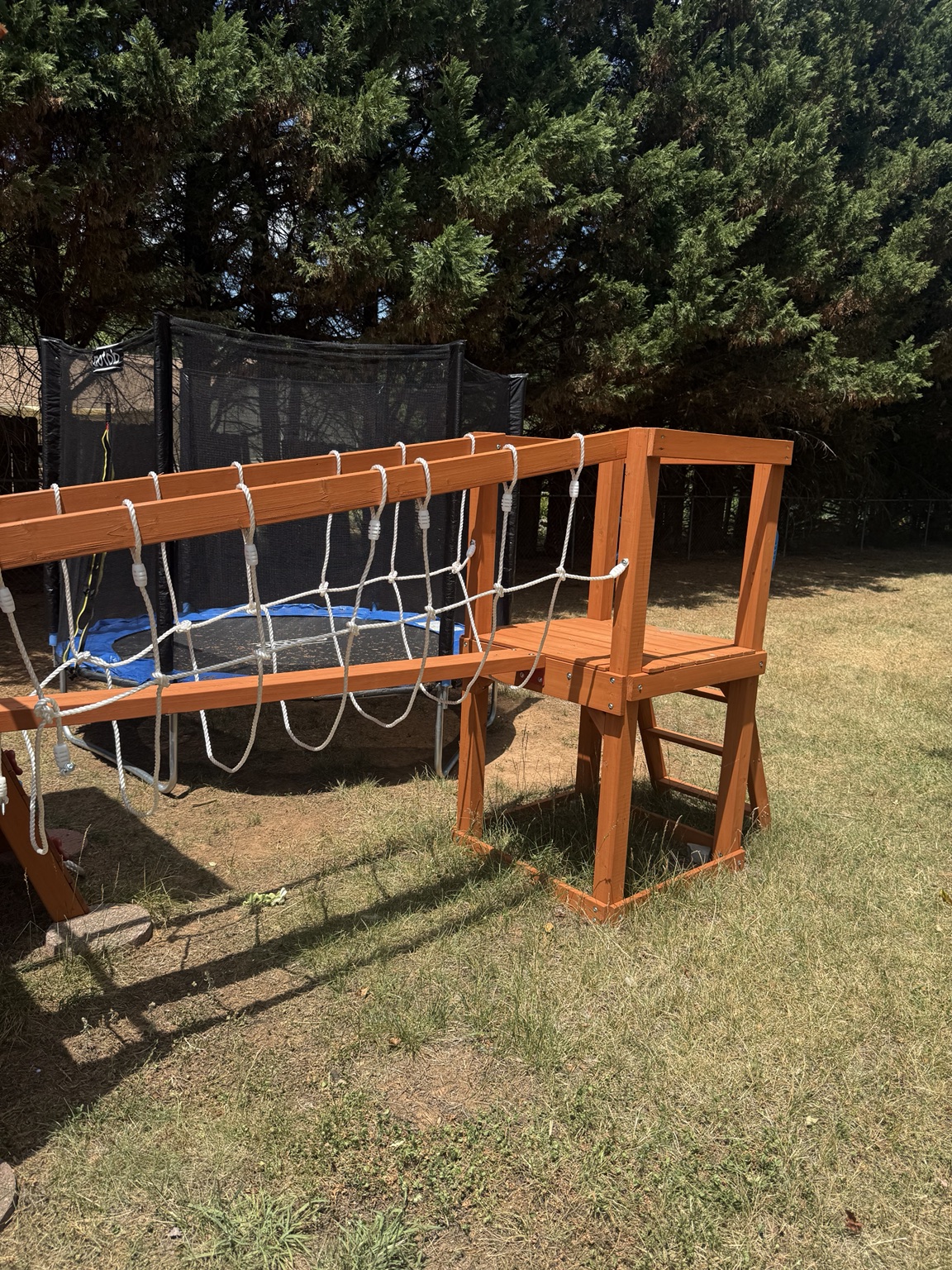 Custom wooden backyard obstacle course and climbing structure