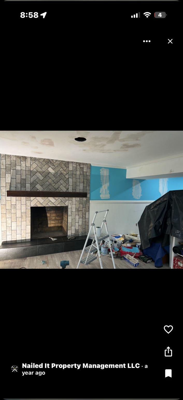 Interior remodeling work in progress featuring a fireplace and kitchen area
